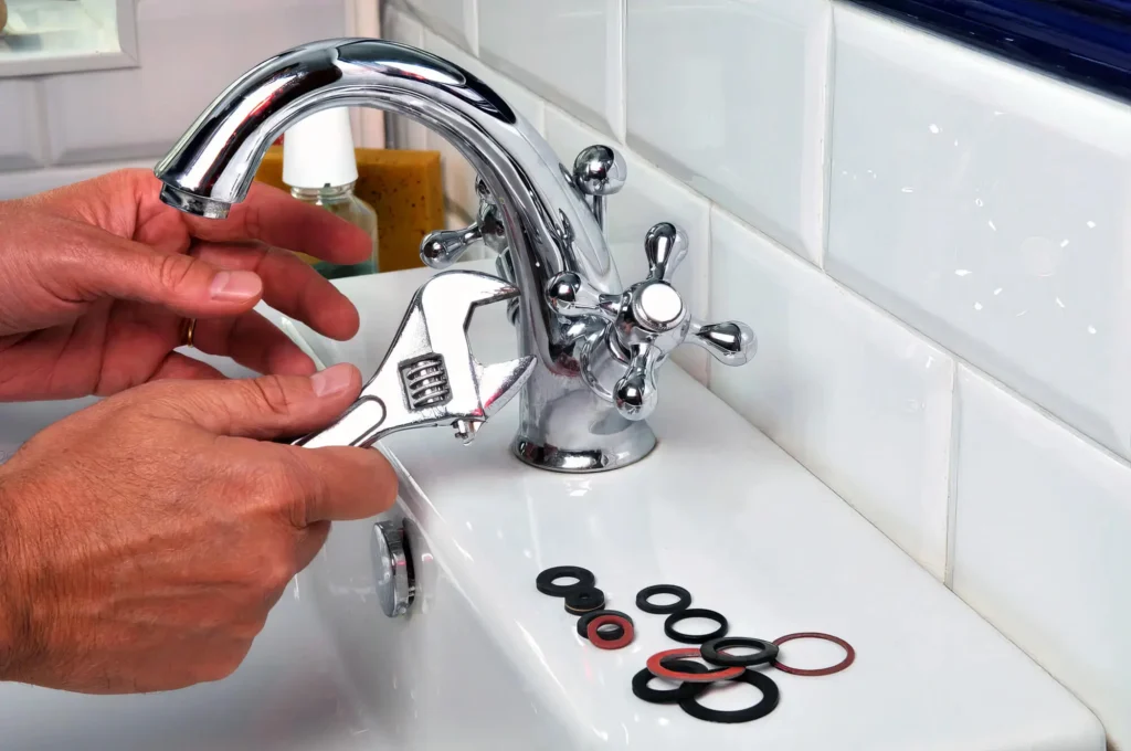 Plumber performing maintenance on a bathroom faucet in Murrieta