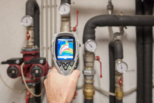 Plumber using a thermal imaging camera to inspect pipes in Murrieta