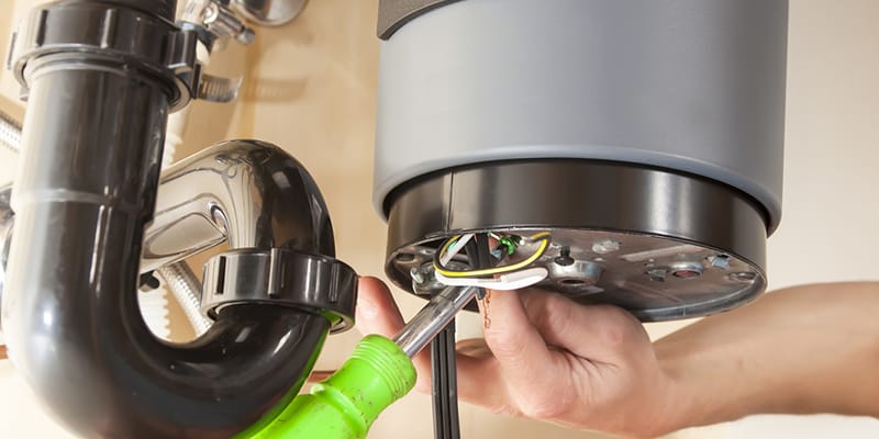 Technician repairing the heating element of a water heater in Murrieta