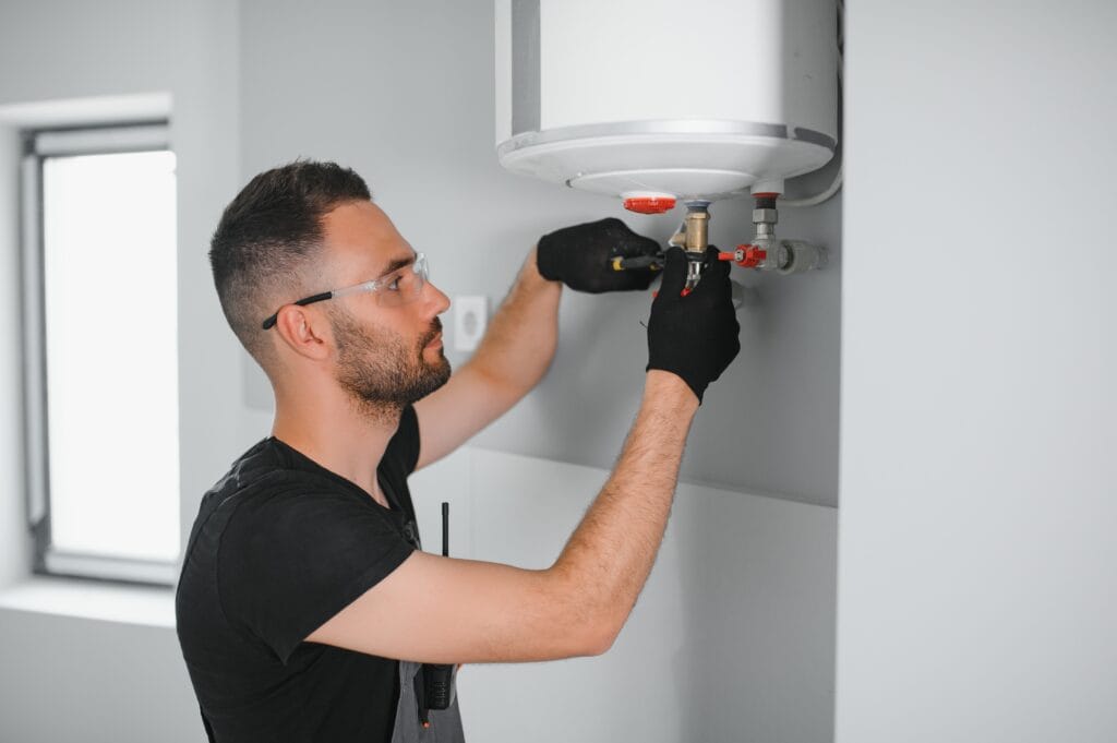 Technician performing water heater maintenance in Murrieta