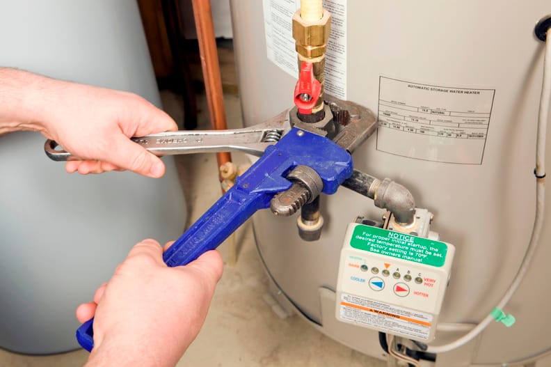 Plumber repairing a water heater valve in Murrieta